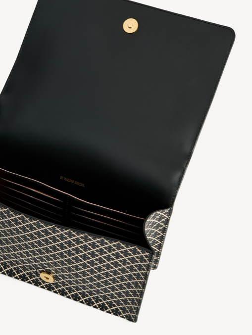 By Malene Birger Loennas cross-over veske i sort, laget av polyvinylklorid, med skinndetaljer, justerbar skulderrem og et romslig interiør.