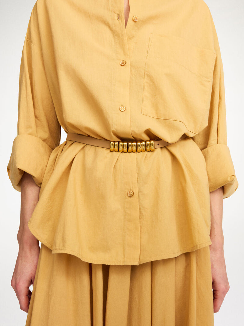 By Malene Birger Ounlo belte i nude, laget av 100% kuskinn, med avtagbare metalldetaljer og et nett design.