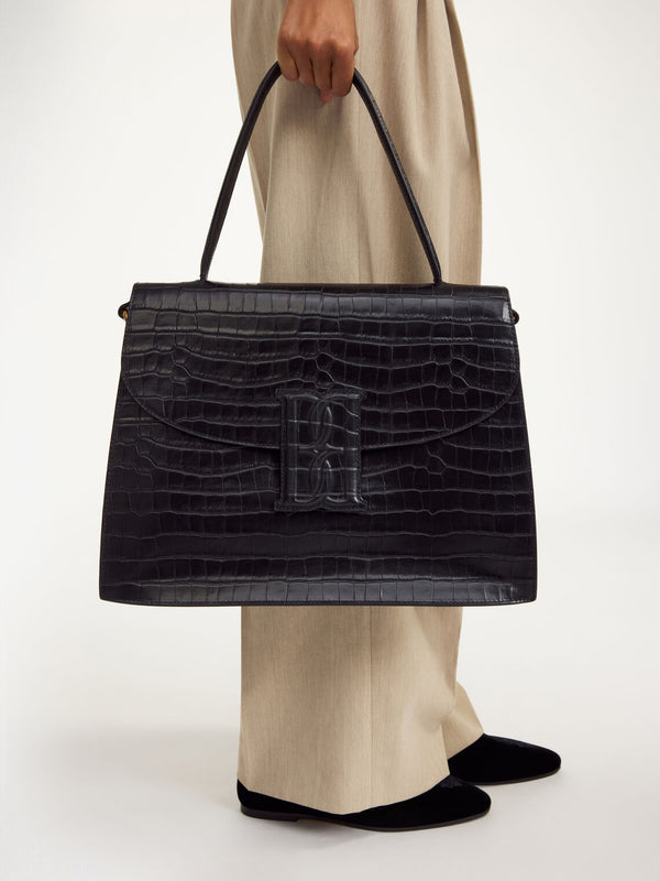 By Malene Birger Ronlas veske i sort kalveskinn med kroko-struktur.